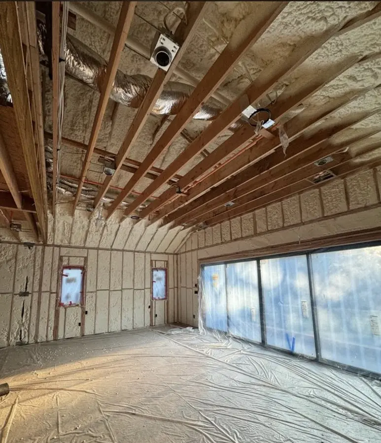 Interior walls and ceiling insulated with spray foam during new construction in King
